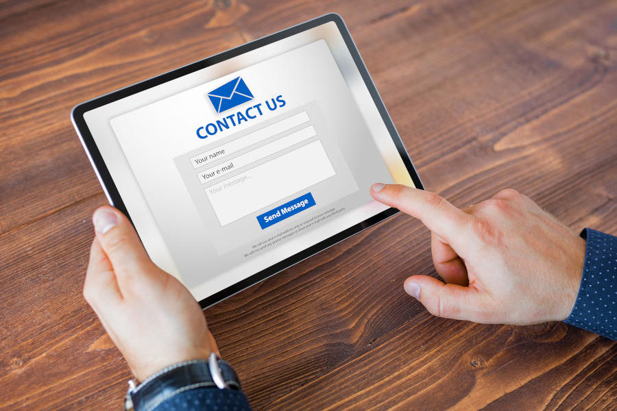 Man submitting contact form on website.